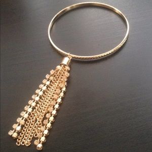 Gold bangle with tassel